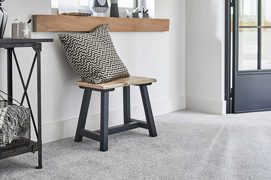 grey living room carpet with industrial wooden bench and black doors